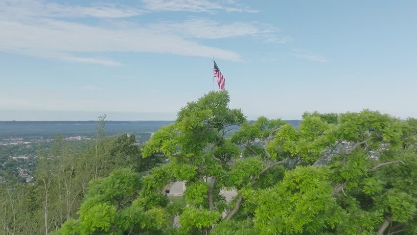Aerial view of Grandad Bluff overlooking the city of La Crosse, the Mississippi River Valley in USA with American flag waving high.