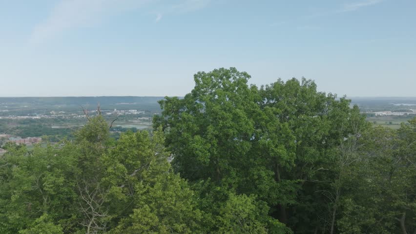 Tilt up drone shot of Grandad Bluff overlooking the city of La Crosse, the Mississippi River Valley, Wisconsin in USA. Famous symbol of the great Driftless Region.