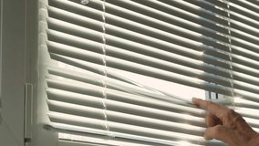 Hand, man peeking through window blinds. Close-up of an old man's hand and window blinds.  - Powered by Shutterstock - Get 15% off with code: PIKWIZARD15