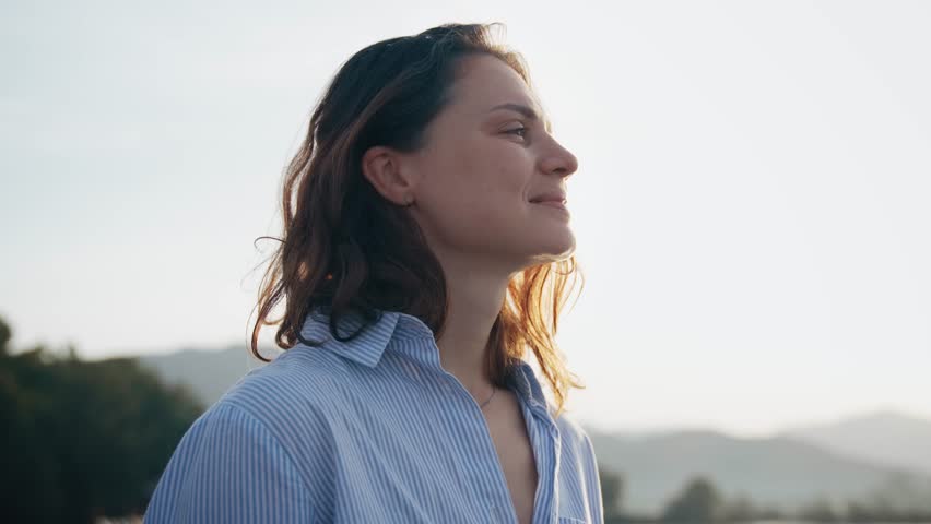 Portrait of a young Caucasian woman enjoying the fresh air and a beautiful view of the sea