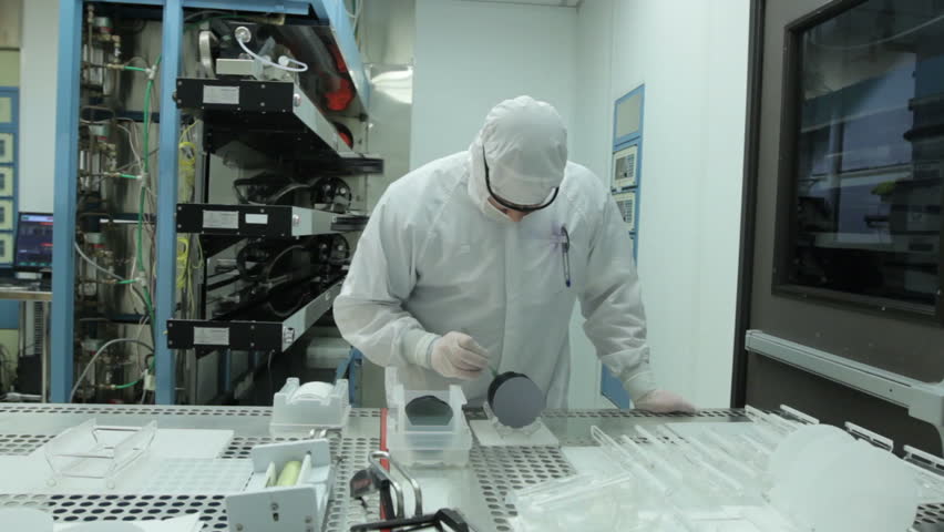 Scientist / technician preps silicon wafers to go into a kiln during silicon