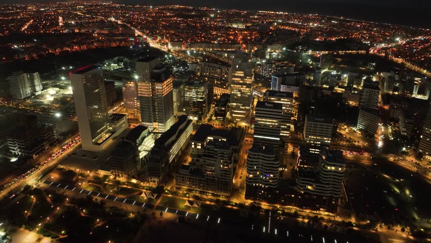 Wide-angle drone shot of modern buildings in Casablanca Finance City (CFC), Morocco. This 4K footage highlights sleek architecture and vibrant cityscapes, ideal for corporate and urban projects.