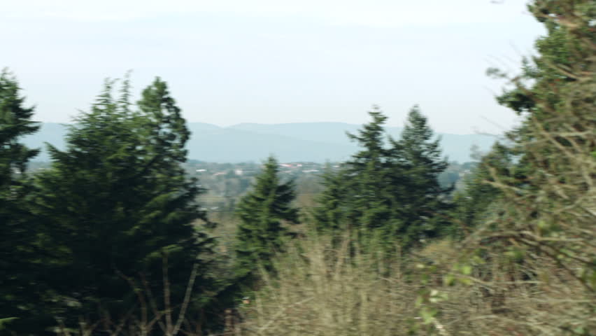 Camera pans and stops on a view of the city of Portland, Oregon, looking west