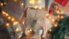 Top view of hands of woman giving Christmas present gift handmade to her friend, New year day and merry Christmas celebration and congratulation - Powered by Shutterstock - Get 15% off with code: PIKWIZARD15