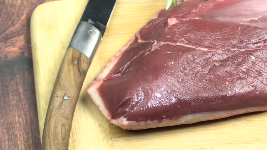 raw duck breast, close-up, on a cutting board