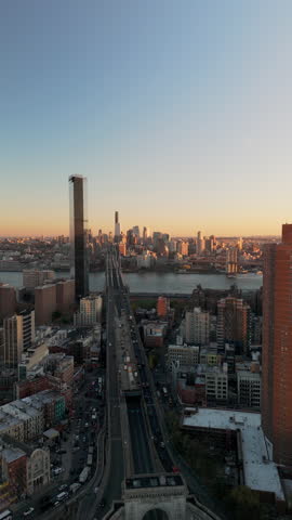 Vertical views of traffic heading to Washington Bridge in Midtown Manhattan, New York City. One Manhattan Square luxury residential skyscraper stands tall in the skyline