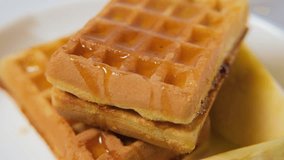 Close-up of hand pouring golden honey on stack of waffles and slices of apples, delightful breakfast, slow motion - Powered by Shutterstock - Get 15% off with code: PIKWIZARD15