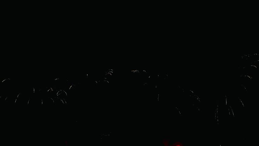 4K. loop seamless of real fireworks background golden shining fireworks with bokeh lights in the night sky. glowing fireworks show. New year