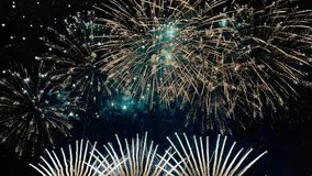 4K. loop seamless of real fireworks background golden shining fireworks with bokeh lights in the night sky. glowing fireworks show. New year's eve fireworks celebration multiple colors  - Powered by Shutterstock - Get 15% off with code: PIKWIZARD15