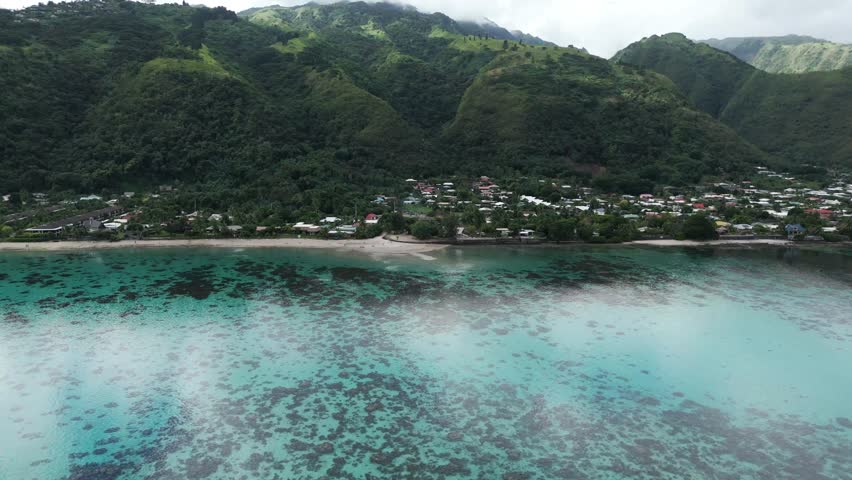 Coastal Village And Tropical Mountain Range At Plage Vaiava Beach In Puna'auia, French Polynesia.