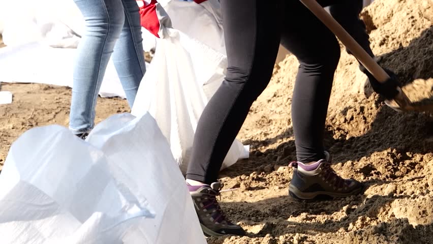 Volunteers filling bags of sand to use for building dam during flooding of Danube River in Hungary.
