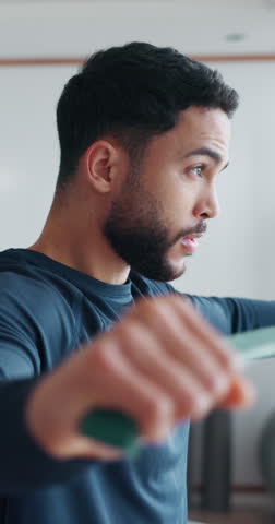 Physiotherapy, resistance band and personal trainer with man in clinic for muscle rehabilitation, help or workout. Performance coach, sports training or athlete with patient for physical therapy