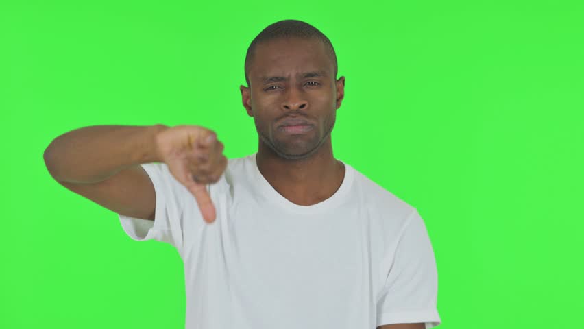 Portrait of African Man with Thumbs Down on Green Background