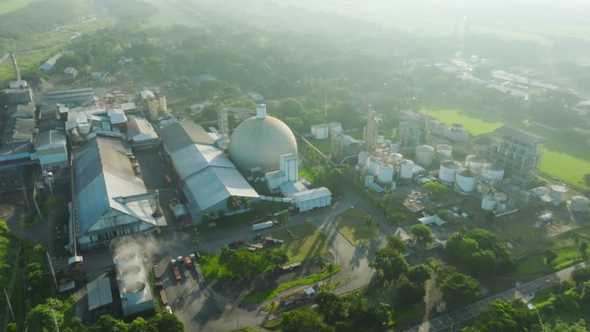 A modern sugar processing and alcohol aging plant, showcasing its impressive infrastructure and vast scale. The aerial perspective reveals the intricate layout of the facility, with processing units.