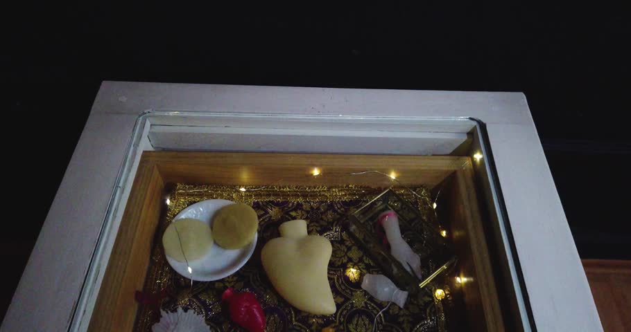 Downward shot of various types of wax figures displayed in a glass case in an exhibition hall in Mexico City