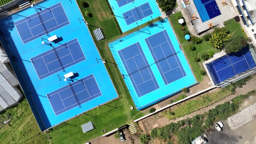 a sports complex designed for active lifestyles and leisure. The facility features multiple courts for pickleball, tennis, padel, and other sports, catering to a wide range of athletic options