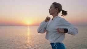 Portrait Young Fit Woman Athlete Running Alone Coastline in Jogging rejoices against blue sky at sunrise summer. Sport dawn workout. Lifestyle. Competition or marathon. Human endurance test. Lifestyle - Powered by Shutterstock - Get 15% off with code: PIKWIZARD15