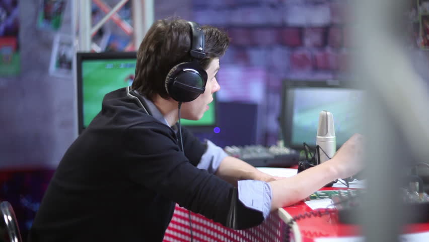 Talking sport event commentator or radio dj in headphones on the air. TV studio