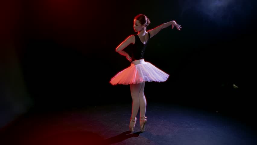 Ballerina in dark rehearsal room, rehearsing night and training over, motivation . Beauty and grace of professional female ballet dancer, tender movements, romantic mood, passionate dance performance