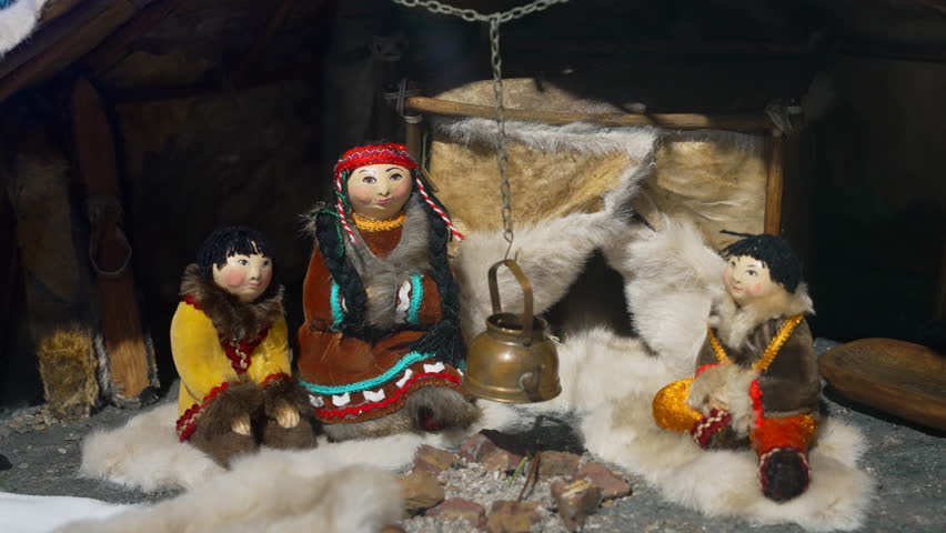 A traditional Inuit family scene featuring handcrafted dolls that represents their rich culture