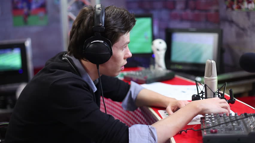 Male commentator of sport event in headphones. Football TV show studio room