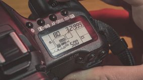 Photographer adjusts the shutter speed on their professional dslr camera, getting ready to take a picture - Powered by Shutterstock - Get 15% off with code: PIKWIZARD15