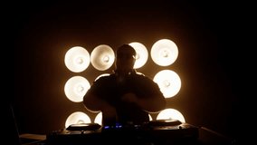 Professional dj mixing music on a console, surrounded by a dazzling wall of lights. The atmosphere pulses with energy and excitement at the vibrant event - Powered by Shutterstock - Get 15% off with code: PIKWIZARD15