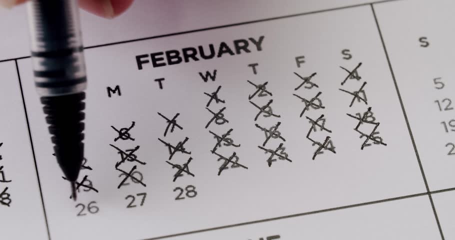 This video shows a time lapse of a person crossing off the days of the month of February on a calendar. Perfect for concepts such as time, deadlines, and the passing of days.