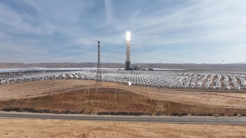 Aerial Drone view from Ashalim power station in Israel
Solar power tower absorbing sunlight from moving mirrors, Drone view, Israel 2024
