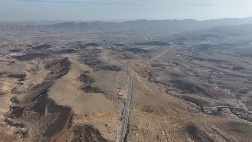 Single white car driving on straight road in the desert. Aerial
Drone view from Israel Ramon Crater desert with White car driving, 2024
