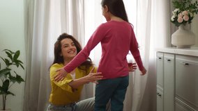 Happy family bonding Caucasian woman female mom mother hug embracing cuddling little girl child kid returning from school lessons daughter hugging foster parent indoors home kitchen. Adoption custody - Powered by Shutterstock - Get 15% off with code: PIKWIZARD15