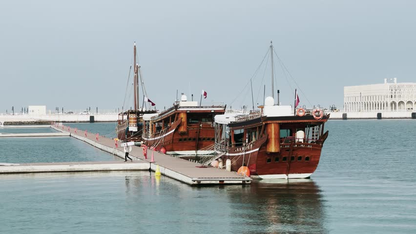 Dhows in front of the City Gallery of New Doha, Qatar on sunny day