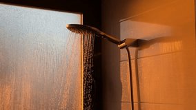 Warm sunlight illuminating modern shower with water droplets falling against frosted glass window - Powered by Shutterstock - Get 15% off with code: PIKWIZARD15