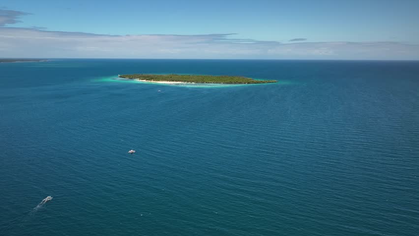 Virgin island with turquoise waters and Hilantagaan island visible in the distance near Cebu Philippines