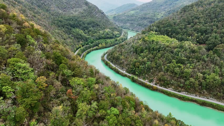 Aerial video of Soca river with its distinctive emerald green colour, nestled between the Julian Alps in western Slovenia.