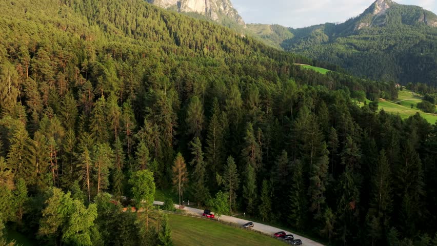 Car with roof tent of park road, surrounded by natural beauty of the Dolomites