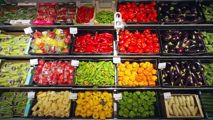 Shelf with Variable Vegetables in a SuperMarket. Ripe Tomatoes Cucumbers Cabbage Peppers Mushrooms Dill Onions etc.