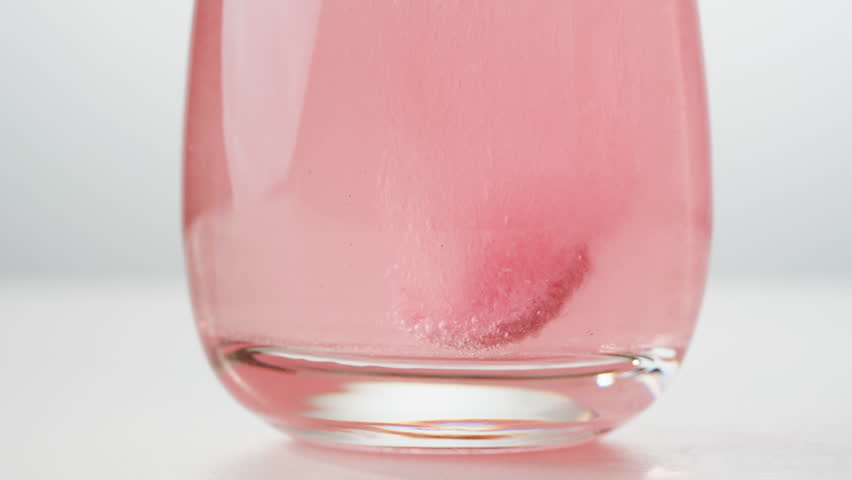 Effervescent tablet vitamin C aspirin nutritional supplements in glass with yellow carbonated water, sport medication, healthy morning. Healthy vitamins D drugs