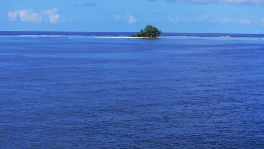 Single island Papeete Tahiti Tapahi Moto Au Mahina Orafara Ahonu French Polynesia aerial drone turquoise water clear waves barrier coral reef white sandy beach palm trees swim snorkel forward pan up