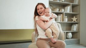 Happy family at home. Mother holding little toddler child daughter. Mom and baby girl relax playing having fun together at home. Mother hugs baby with love care. Mom of breast feeding baby - Powered by Shutterstock - Get 15% off with code: PIKWIZARD15