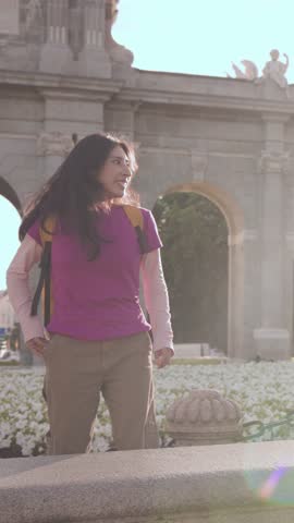 Young Peruvian tourist taking selfies in slow motion at Puerta de Alcala