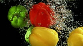 Fresh bell peppers falling into water on slow motion - Powered by Shutterstock - Get 15% off with code: PIKWIZARD15