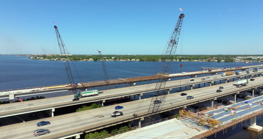 Driving traffic cars on freeway bridge road under construction. Building traffic infrastructure on American roadway.