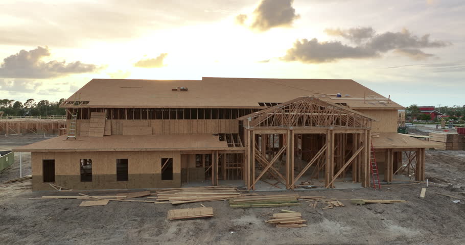 Wooden apartment building under construction in new developing suburban area. Development of residential housing in Florida suburbs. Real estate market in the USA.