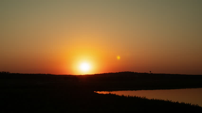 Sunset timelapse in Canyon Lake, Texas in the hill country, vibrant orange colors transition to twilight