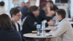 Group of professionals having focused conversation during business networking event at conference venue - Powered by Shutterstock - Get 15% off with code: PIKWIZARD15