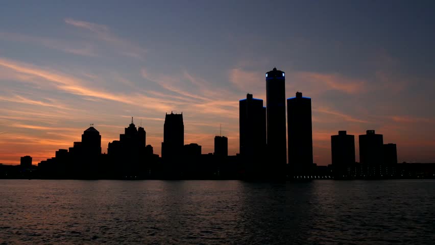silhouetted detroit skyline at sunset stock video