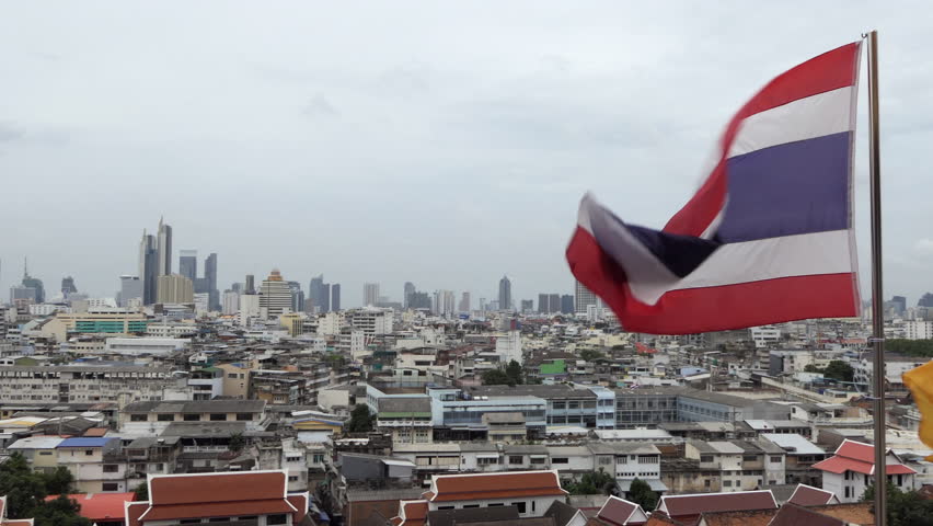 Urban view of Bangkok, Thailand, Asia with Thai flag
