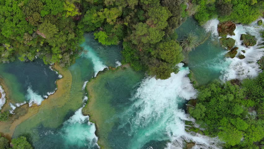 Aerial top view of beautiful Krka Waterfalls in Krka National Park, green foliage and turquoise water, Croatia, 4k