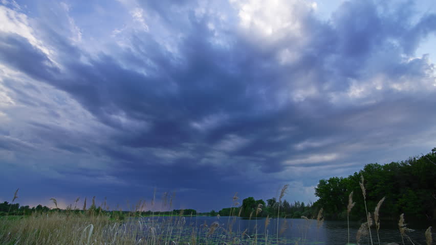 time lapse with storm clouds moving over lake, 4k